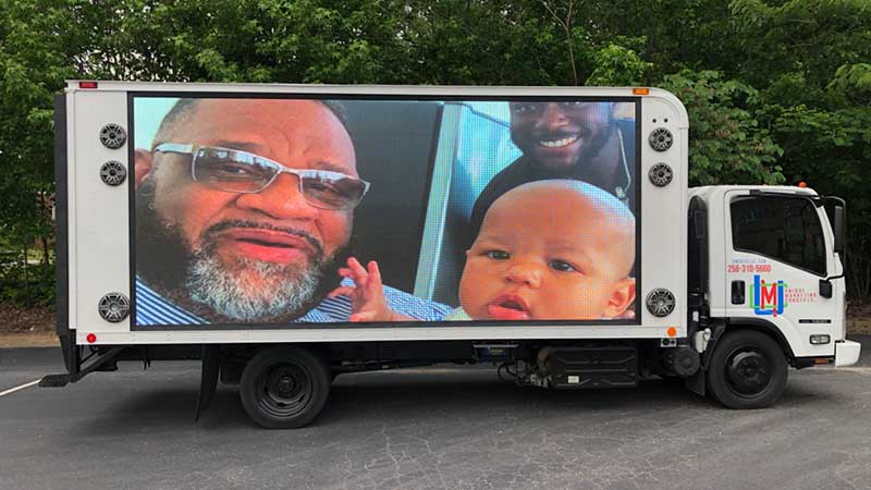 A photo memorial set to music and playing on our led digital billboard truck